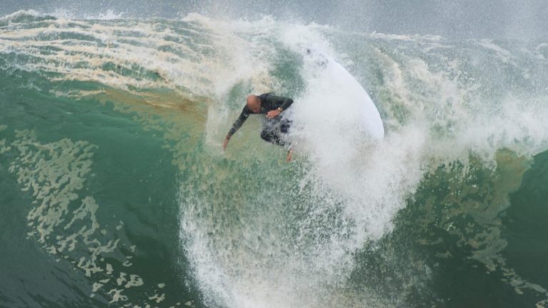 Kelly Slater Faces Off Against Sydney's Massive Surf Swells